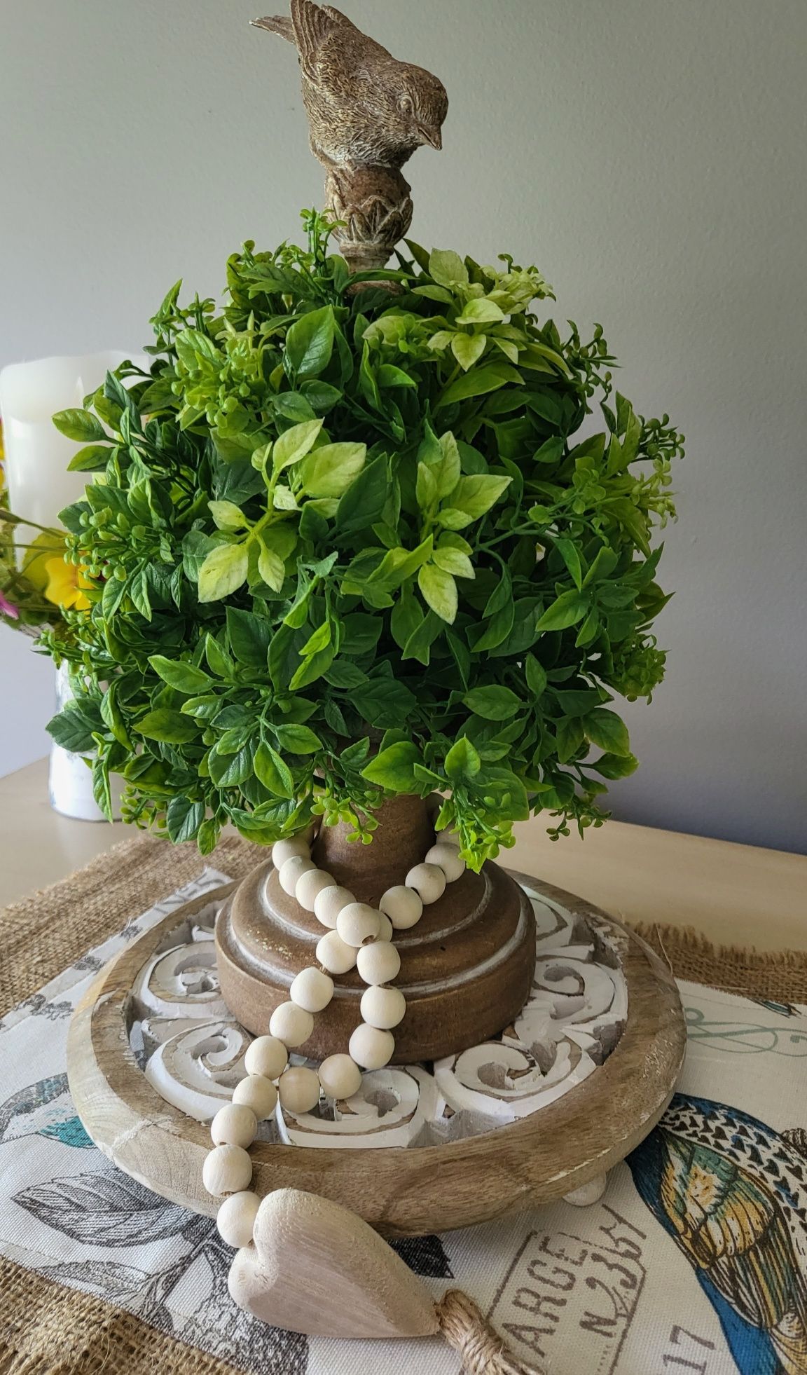 interior decorating tips: a small tree with a bird on top of it is on a table .