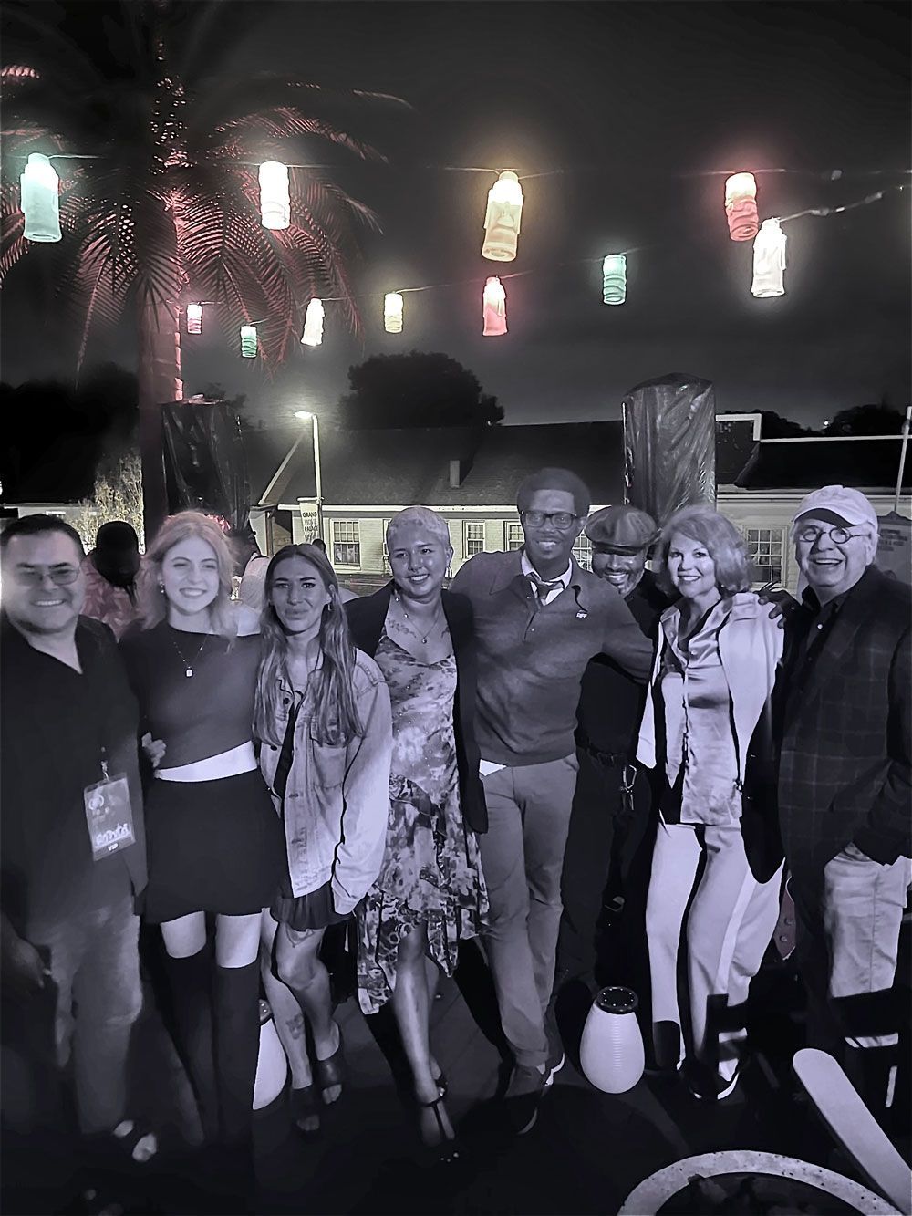 A black and white photo of a group of people posing for a picture