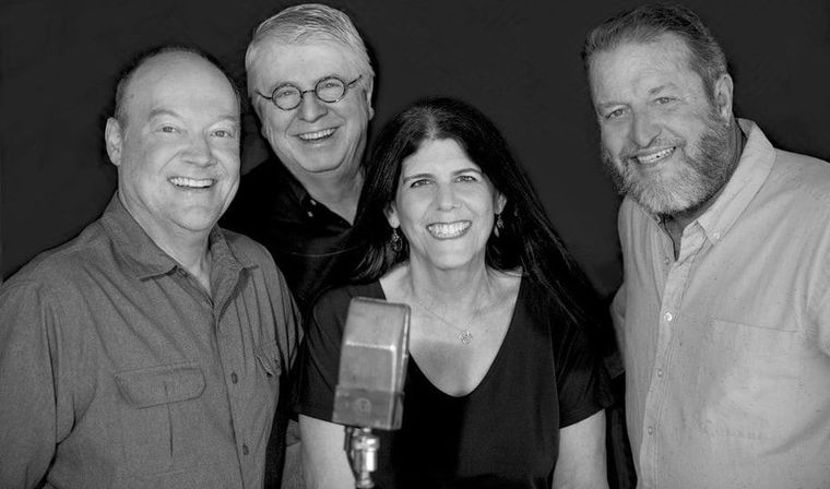 A group of people are posing for a picture in a black and white photo.