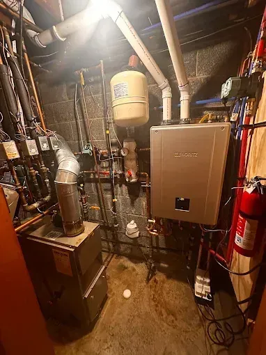 Basement with heating equipment, water heater, expansion tank, and a fire extinguisher.