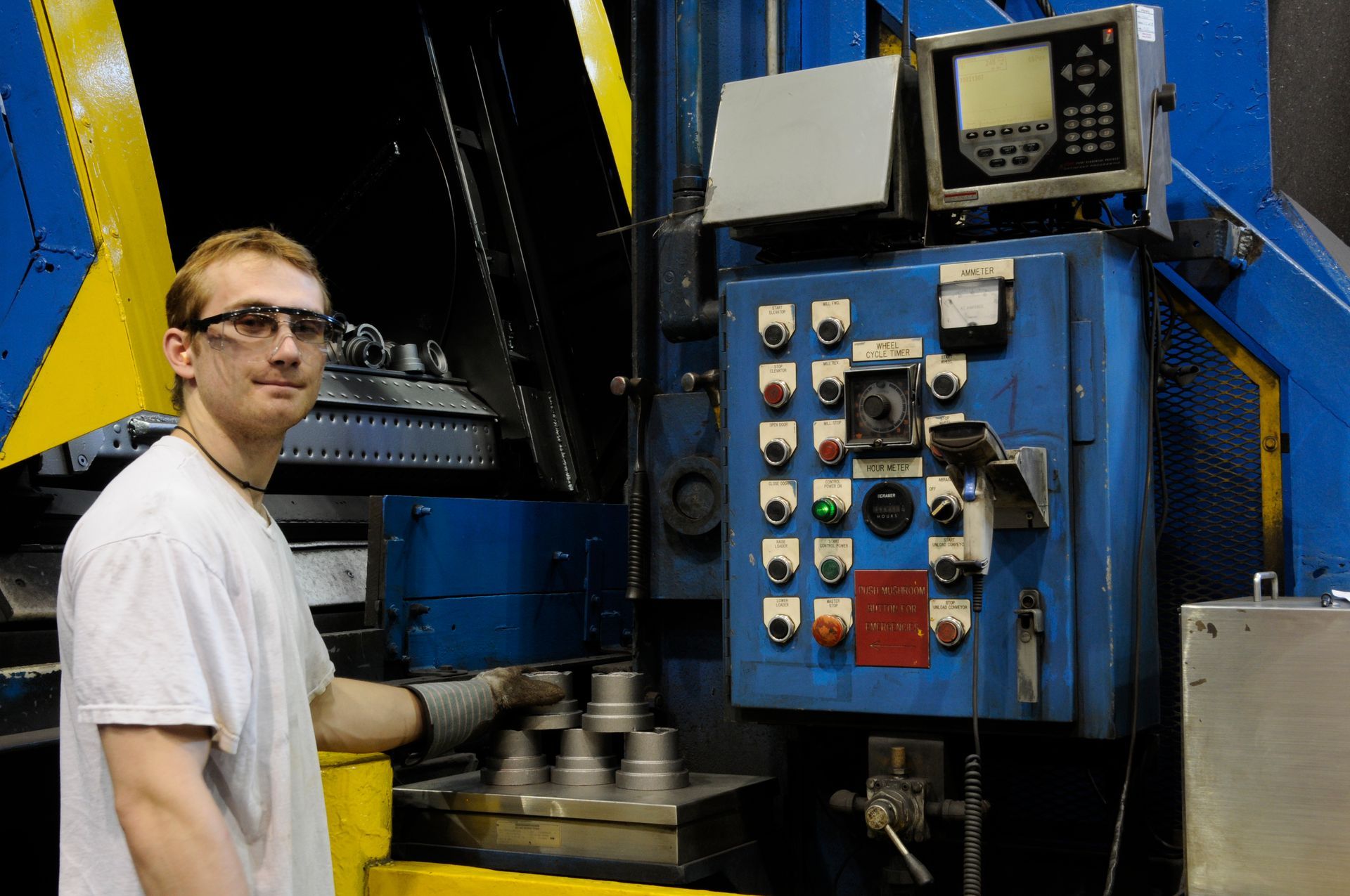 Man operating heat treat machine.