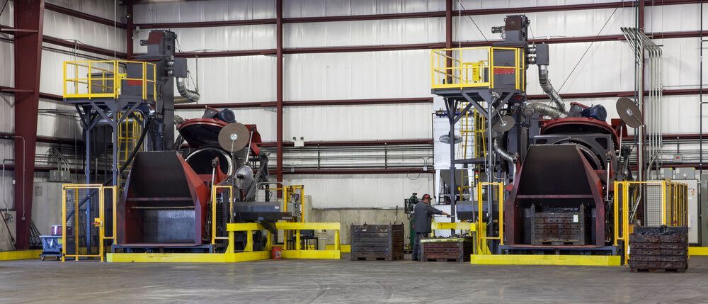 Man operating large heat treat machine.