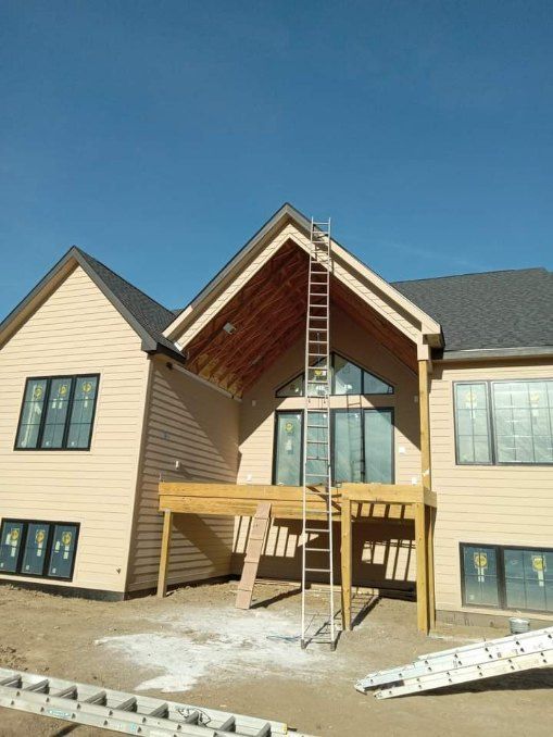 A large house with a ladder on the side of it