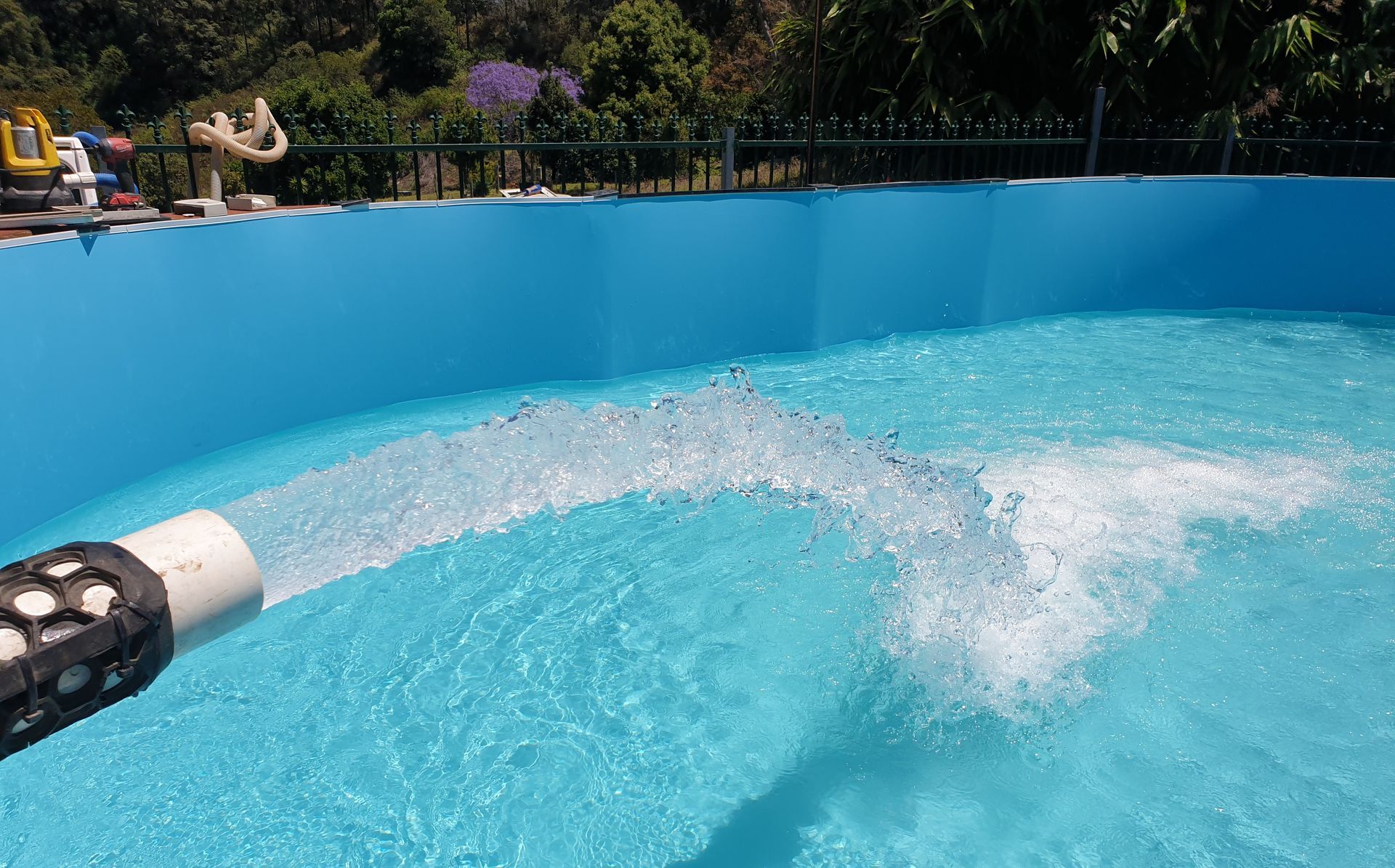 A Man is Working on a Swimming Pool With Trees in the Background — Water 4 You In Clovass, NSW