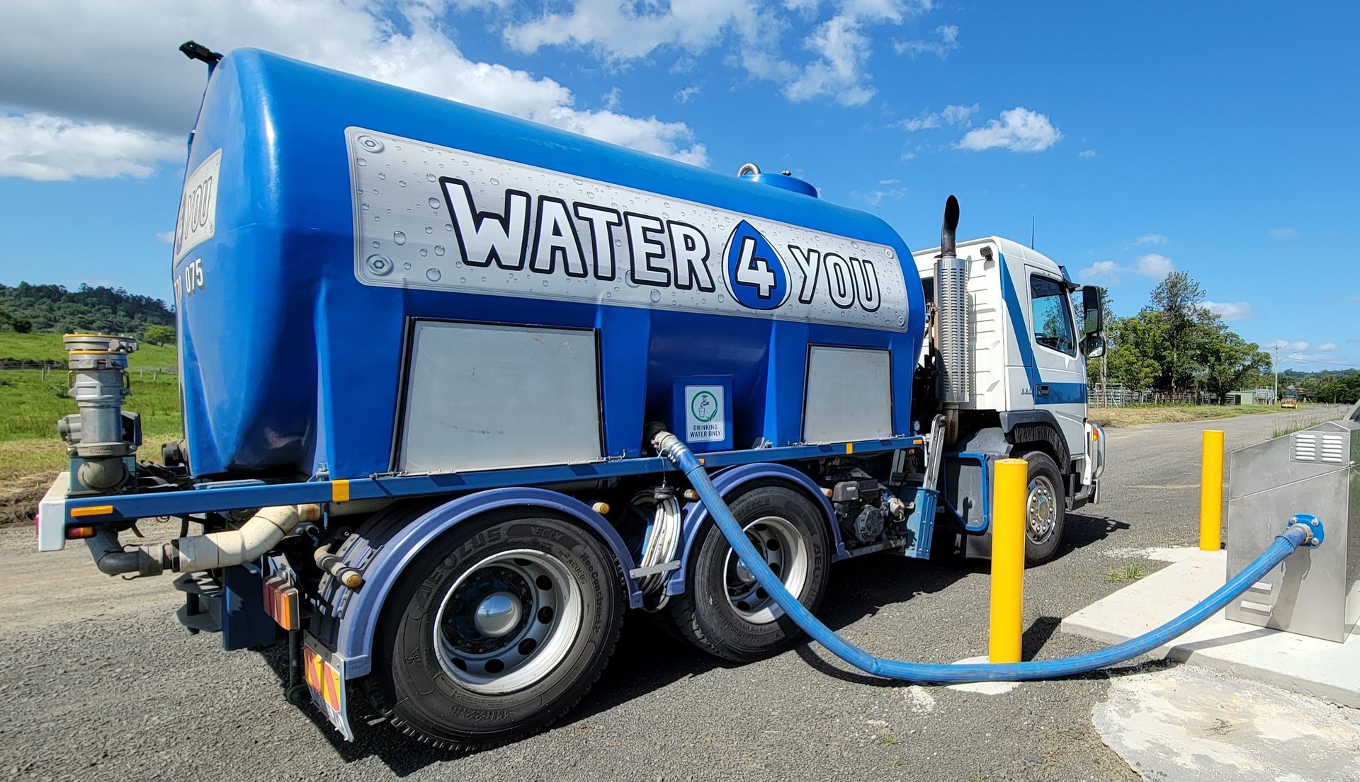 A Hose is Pouring Water Into a Muddy Container — Water 4 You In Clovass, NSW