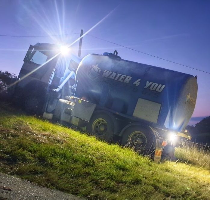 A Water Truck is Sitting on the Side of the Road at Night — Water 4 You in Clovass, NSW