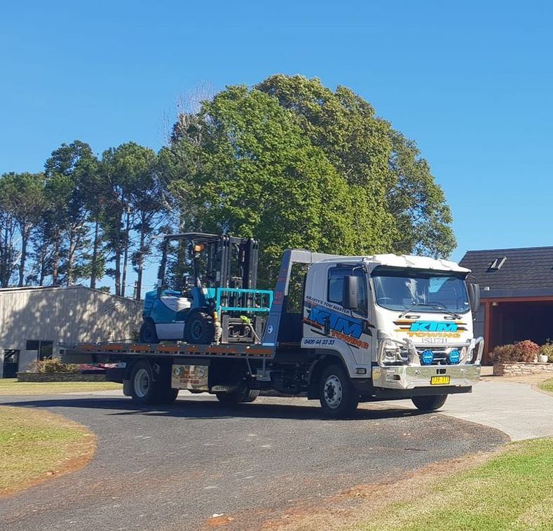 A Forklift Is On The Back Of A Tow Truck — KTM Towing In Macksville, NSW