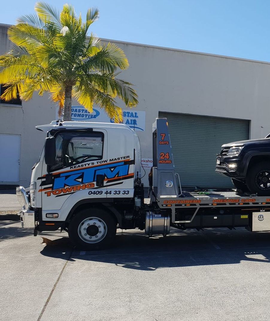 Black Ute Being Towed By Tow Truck — KTM Towing In Kempsey, NSW