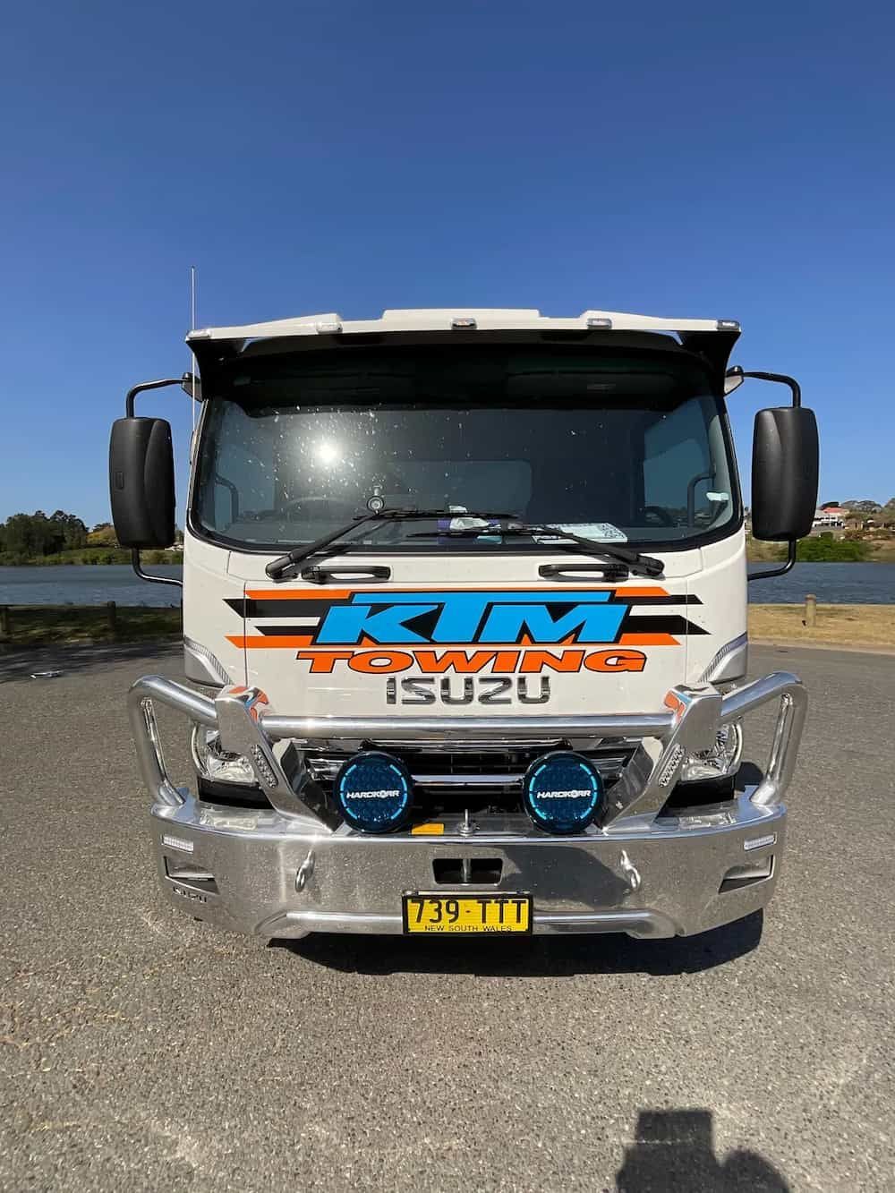 A White Truck With The Word Rim On The Front Is Parked In A Parking Lot — KTM Towing In Wauchope, NSW