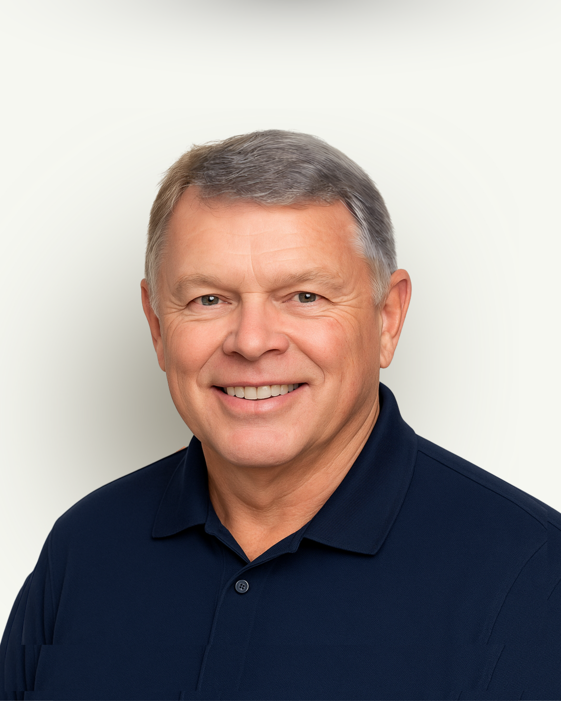 A man in a blue shirt is smiling for the camera.