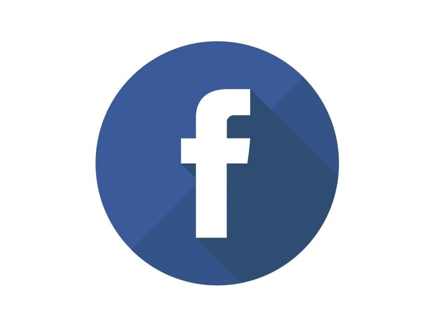 A facebook logo in a blue circle with a long shadow on a white background.