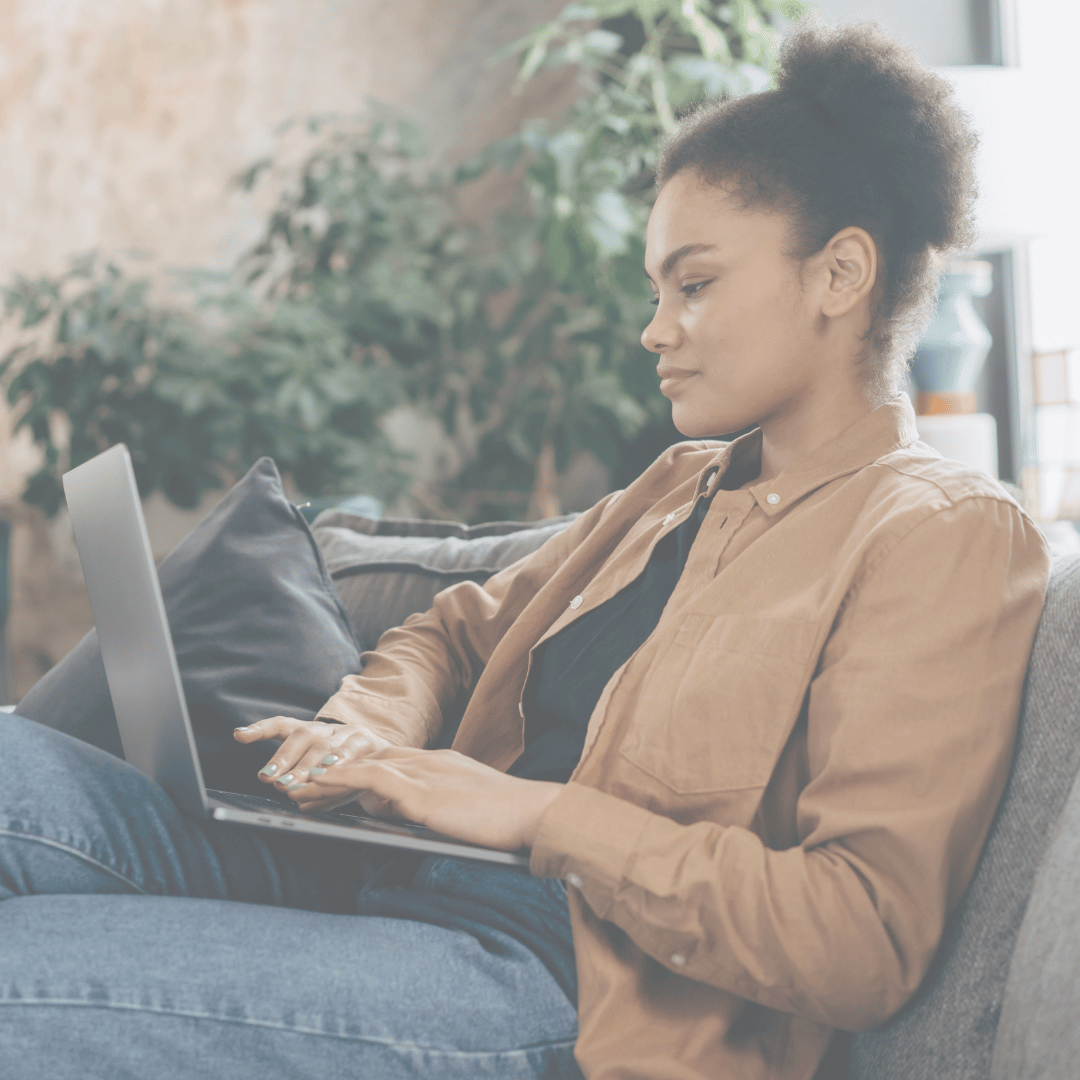 Woman sitting on the couch using her computer