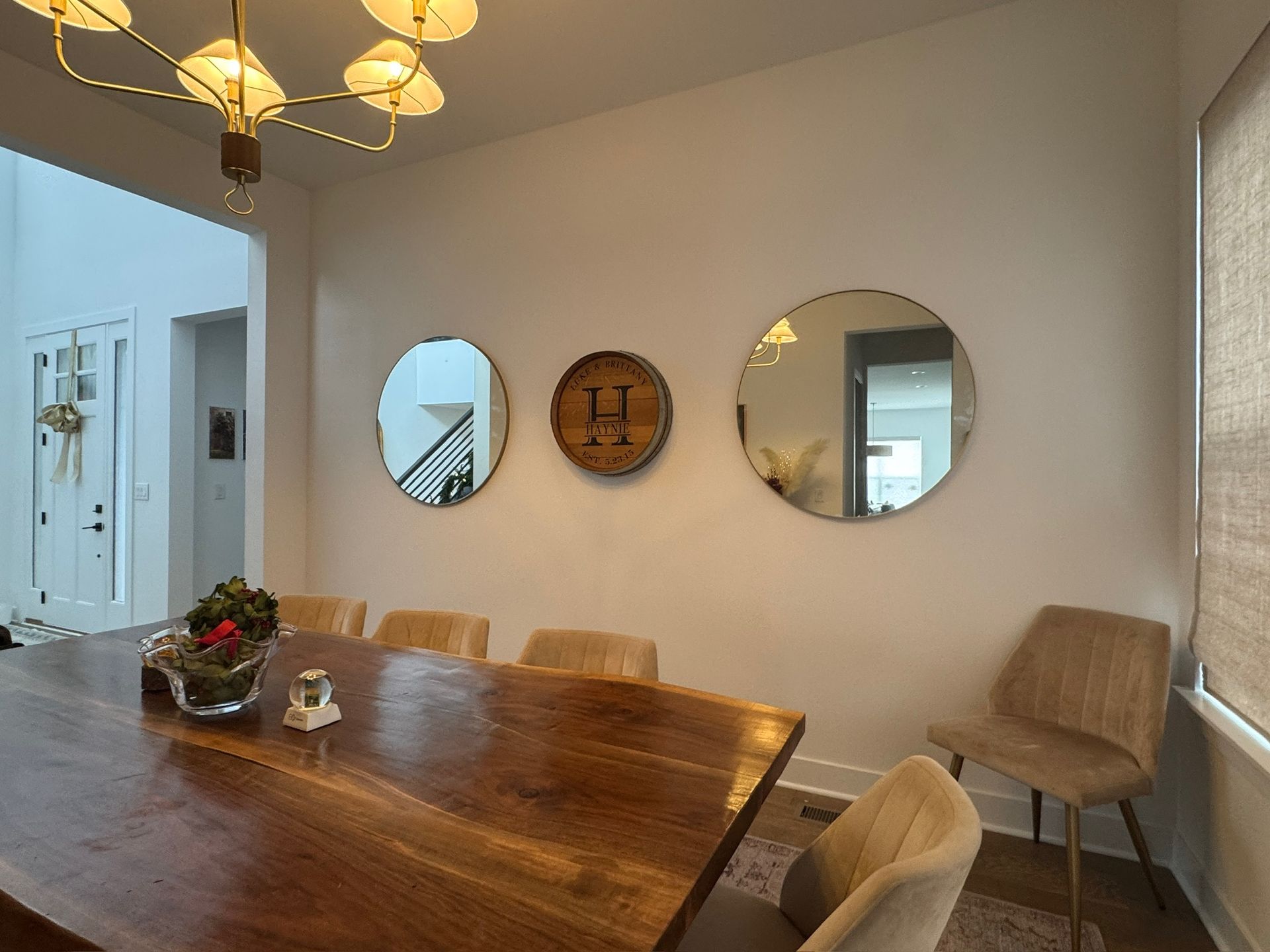 A man is measuring a cabinet with a tape measure in a kitchen.