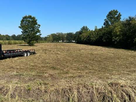 A trailer is parked in the middle of a field.