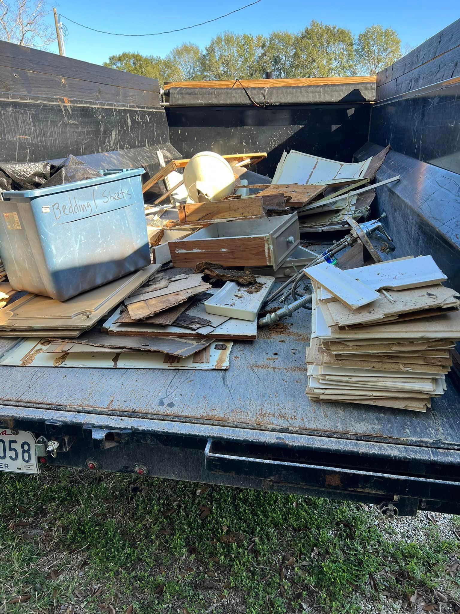 A dumpster filled with a lot of cardboard and wood.