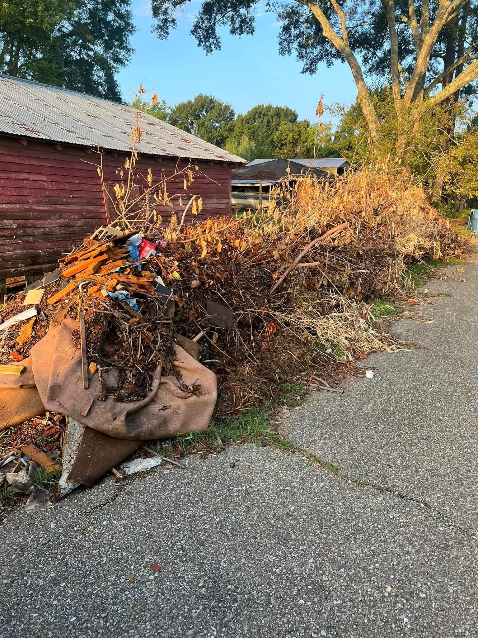 There is a large pile of trash on the side of the road.
