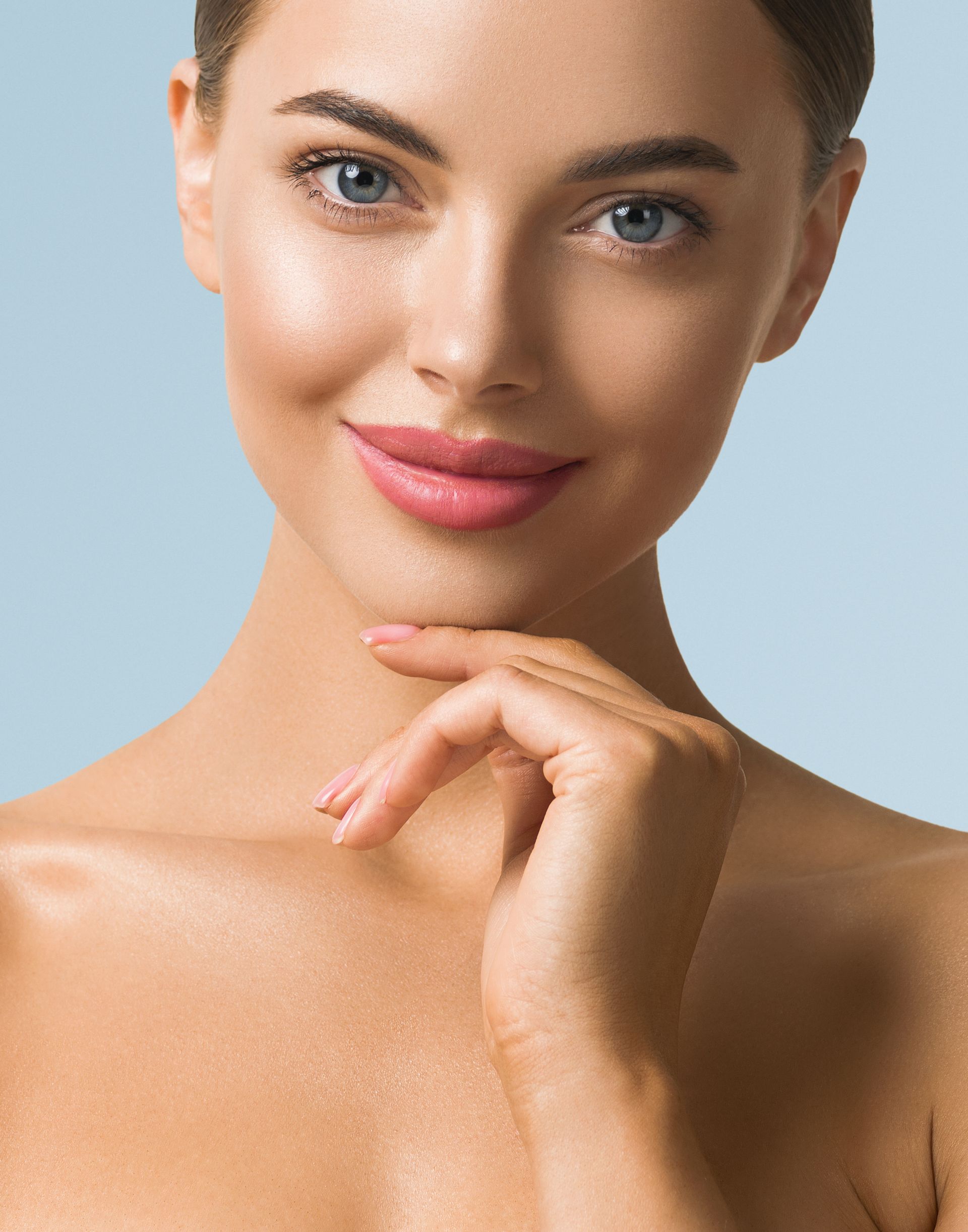 A close up of a woman 's face with her hand on her chin.