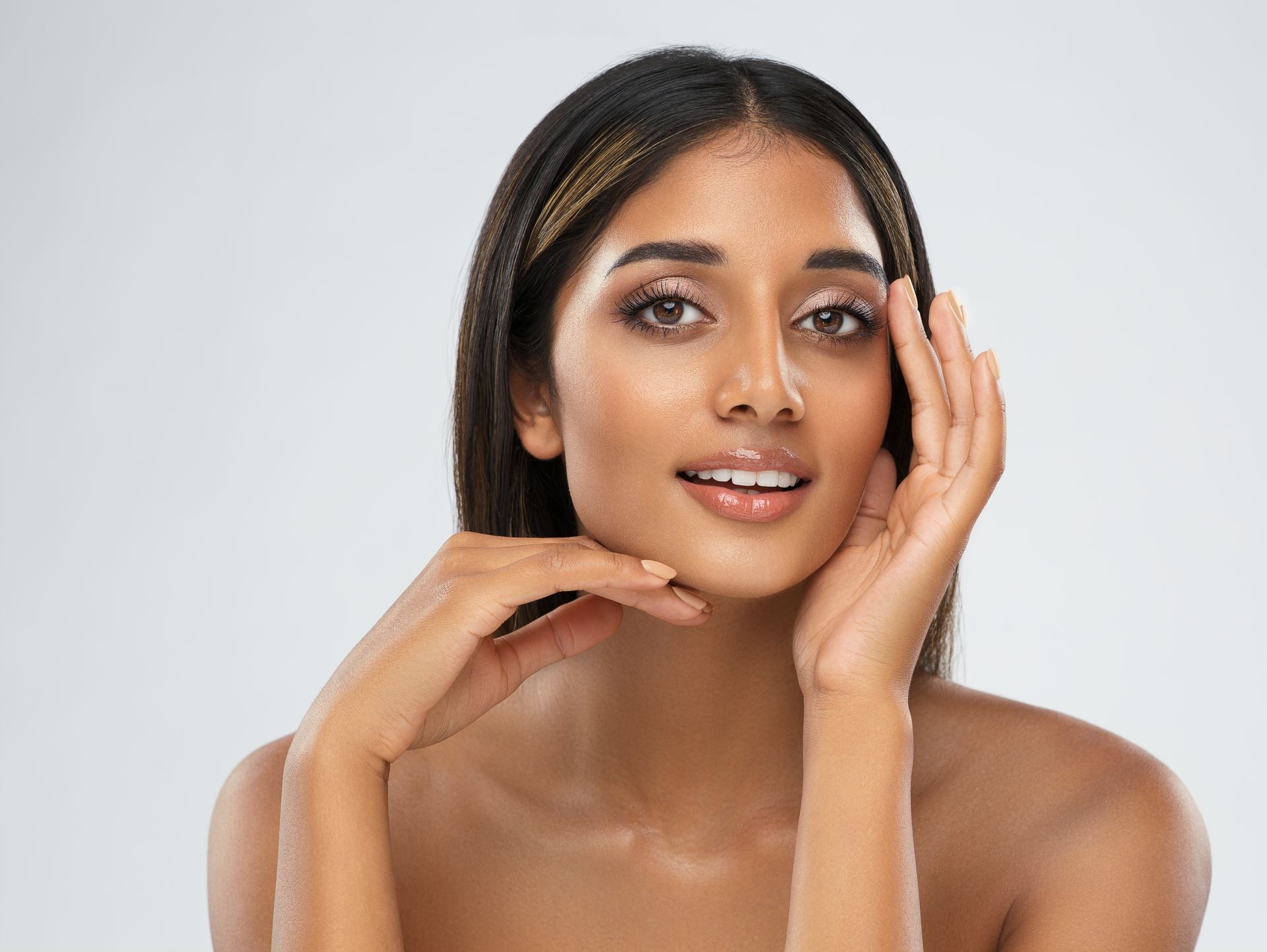 A close up of a woman 's face with a healthy skin.