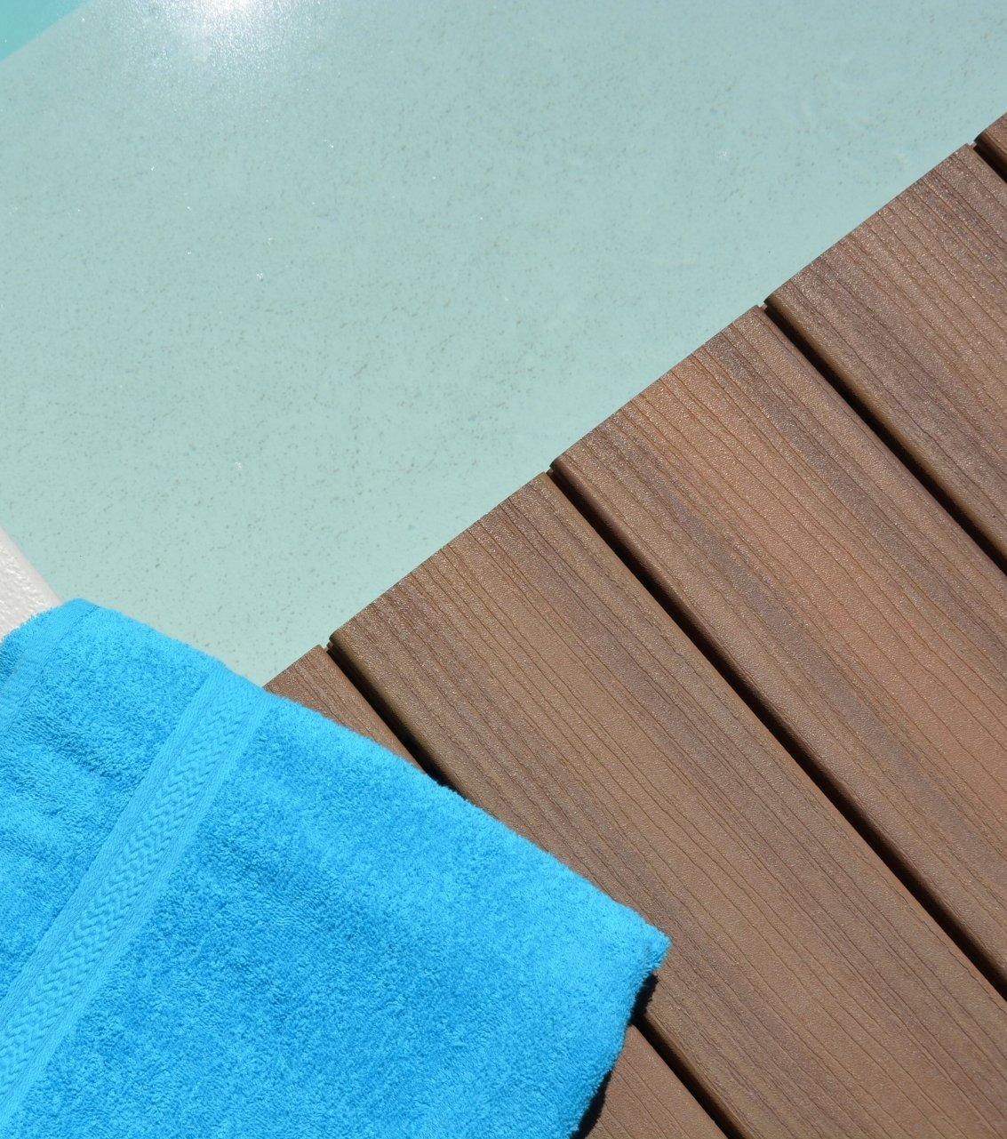 a towel by the edge of a wooden pool