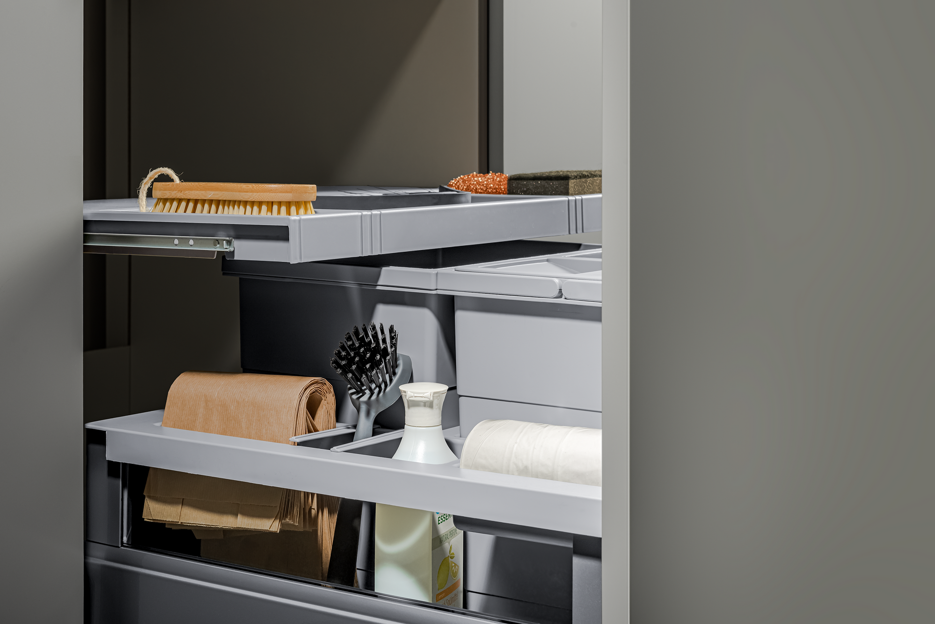 A gray, pull-out cabinet with shelves containing various bathroom items like brushes and towels.