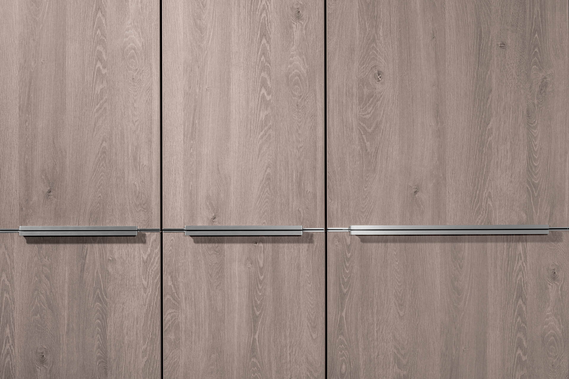Three wooden cabinet doors with horizontal silver handles, in a close-up shot.