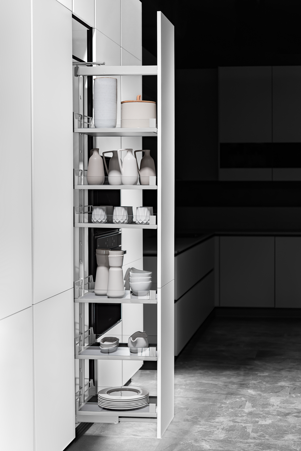 A tall, white, pull-out pantry in a modern kitchen displays organized food items. The open cabinet reveals various shelves with bottles, jars, and containers.