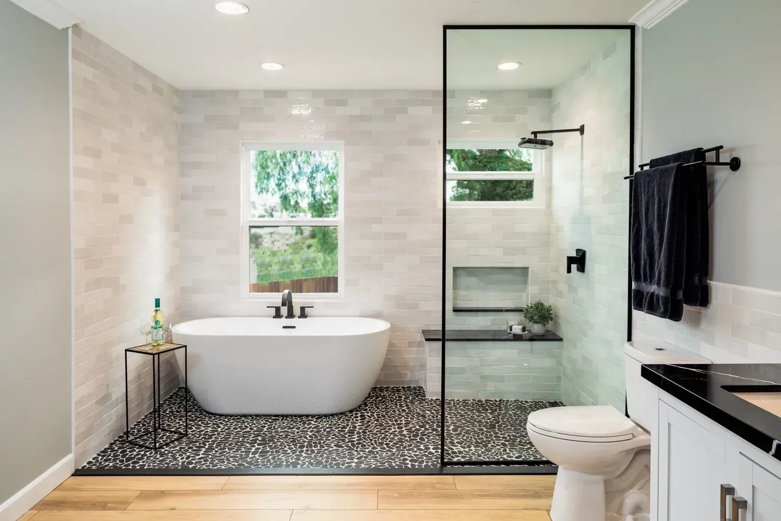 Modern ensuite design with walk-in shower, freestanding bath, and patterned tile flooring in Northbridge”
