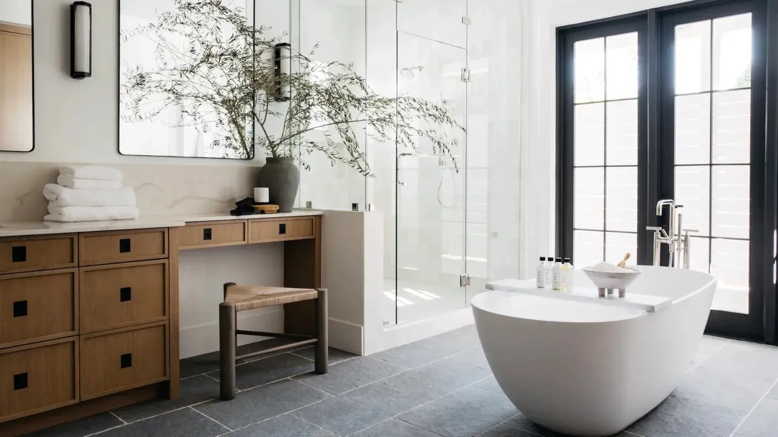 Freestanding bath with timber vanity and neutral tones in a Lower North Shore bathroom”
