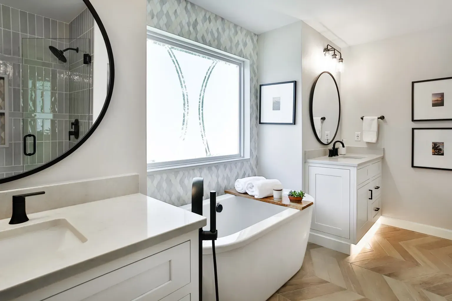 Bright bathroom with black tapware, custom panel vanity, and freestanding bath under feature window in Cremorne”
