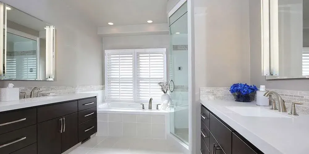 A bathroom with two sinks, a tub, and a walk-in shower in Mosman