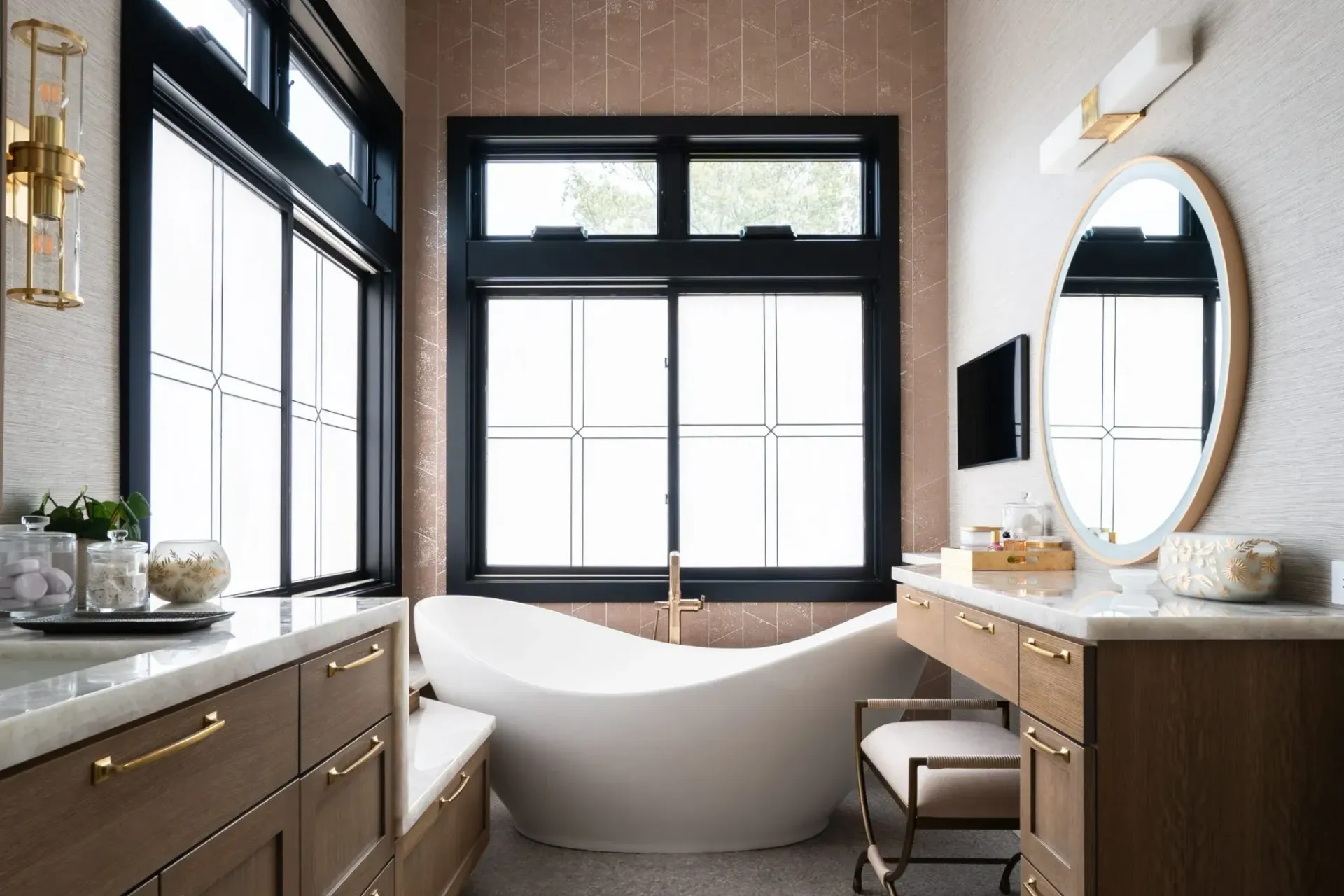 Freestanding feature bath with twin vanities and full-height windows in a Lower North Shore ensuite design”
