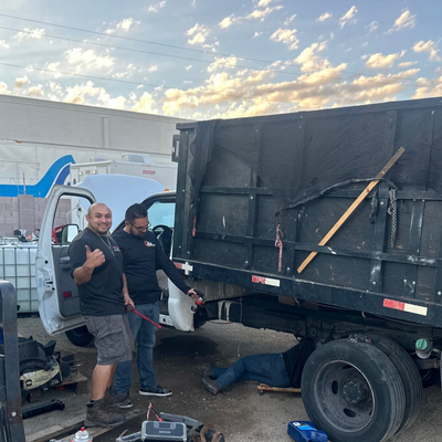 a row of red semi trucks parked next to each other