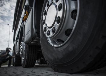 a close up of a truck wheel on a brick road .