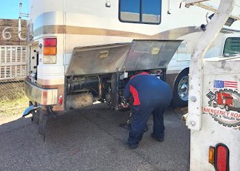 a man is working on the back of a rv .