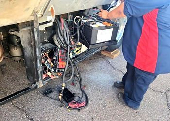 a man is working on a rv battery .
