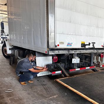a man is working on a car engine with a wrench .