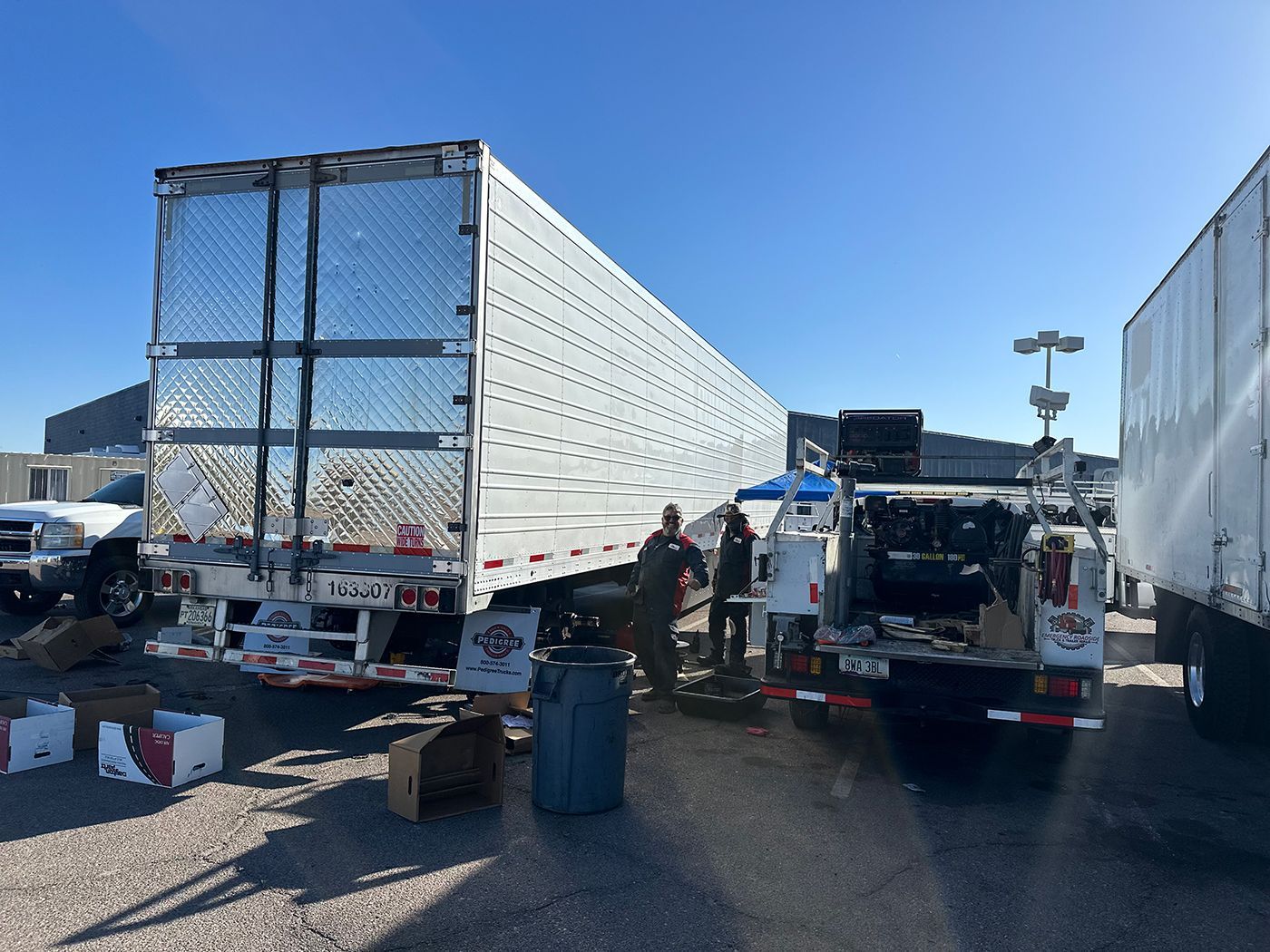 Two semi trucks are parked next to each other in a parking lot