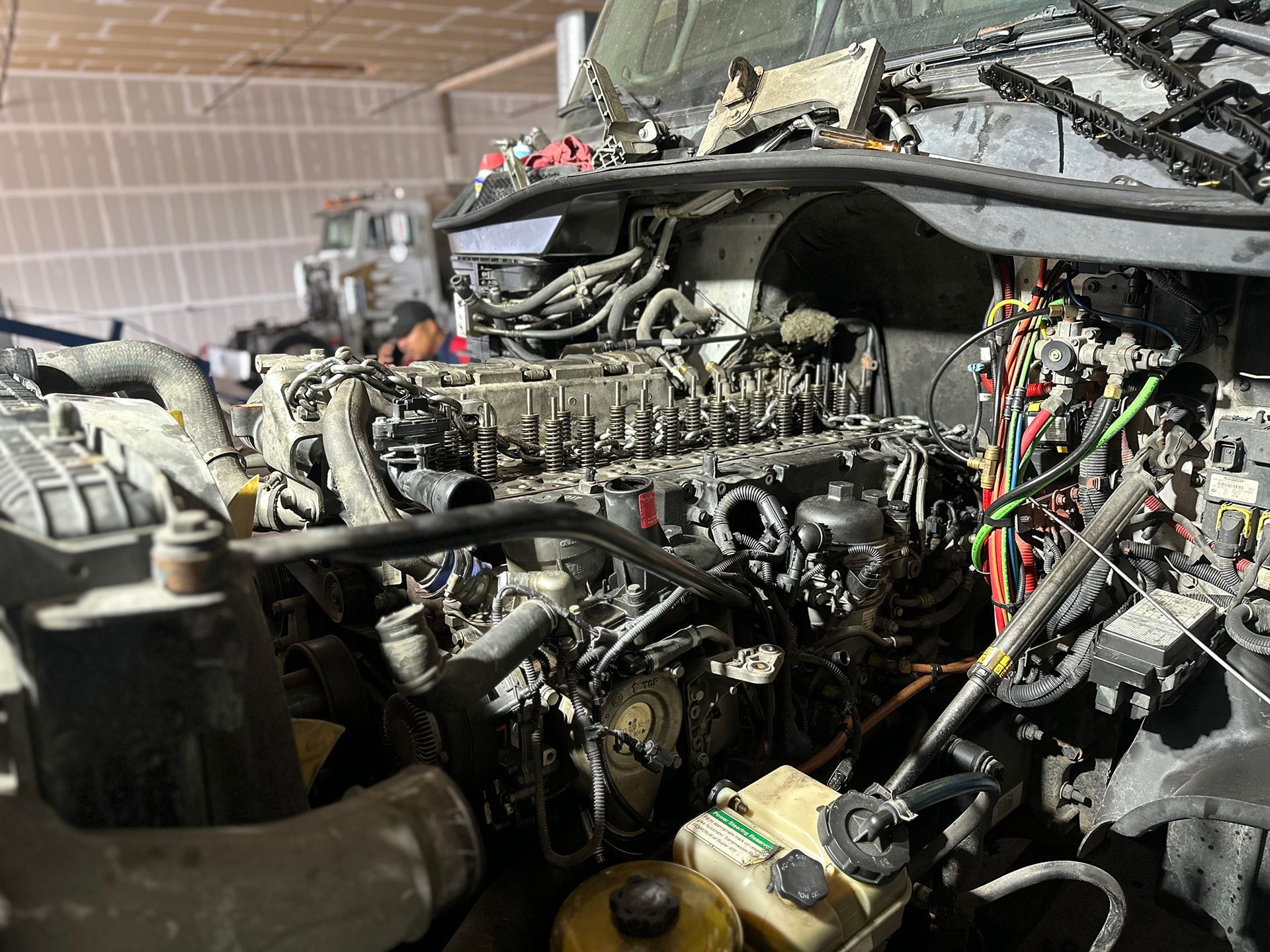 A close up of a car engine in a garage.