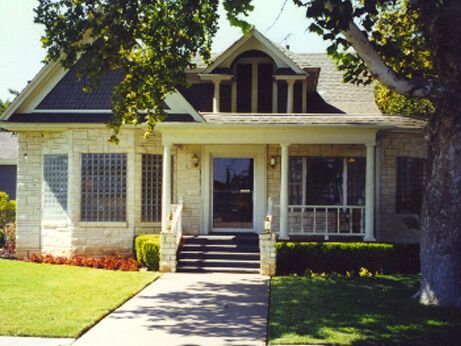 A funeral home with a black awning over the door