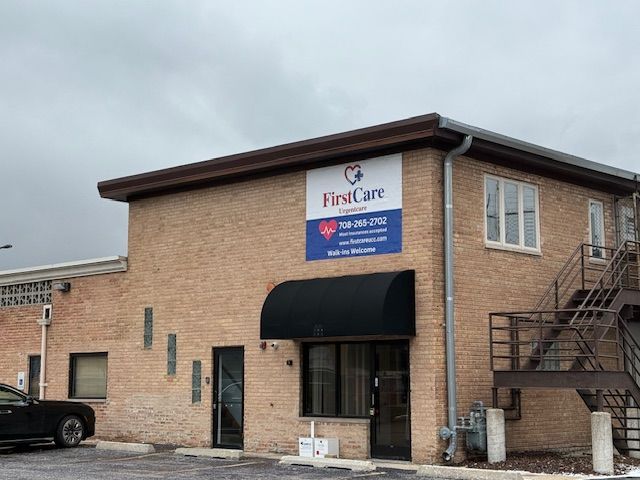 A brick building with a sign that says first care on it.