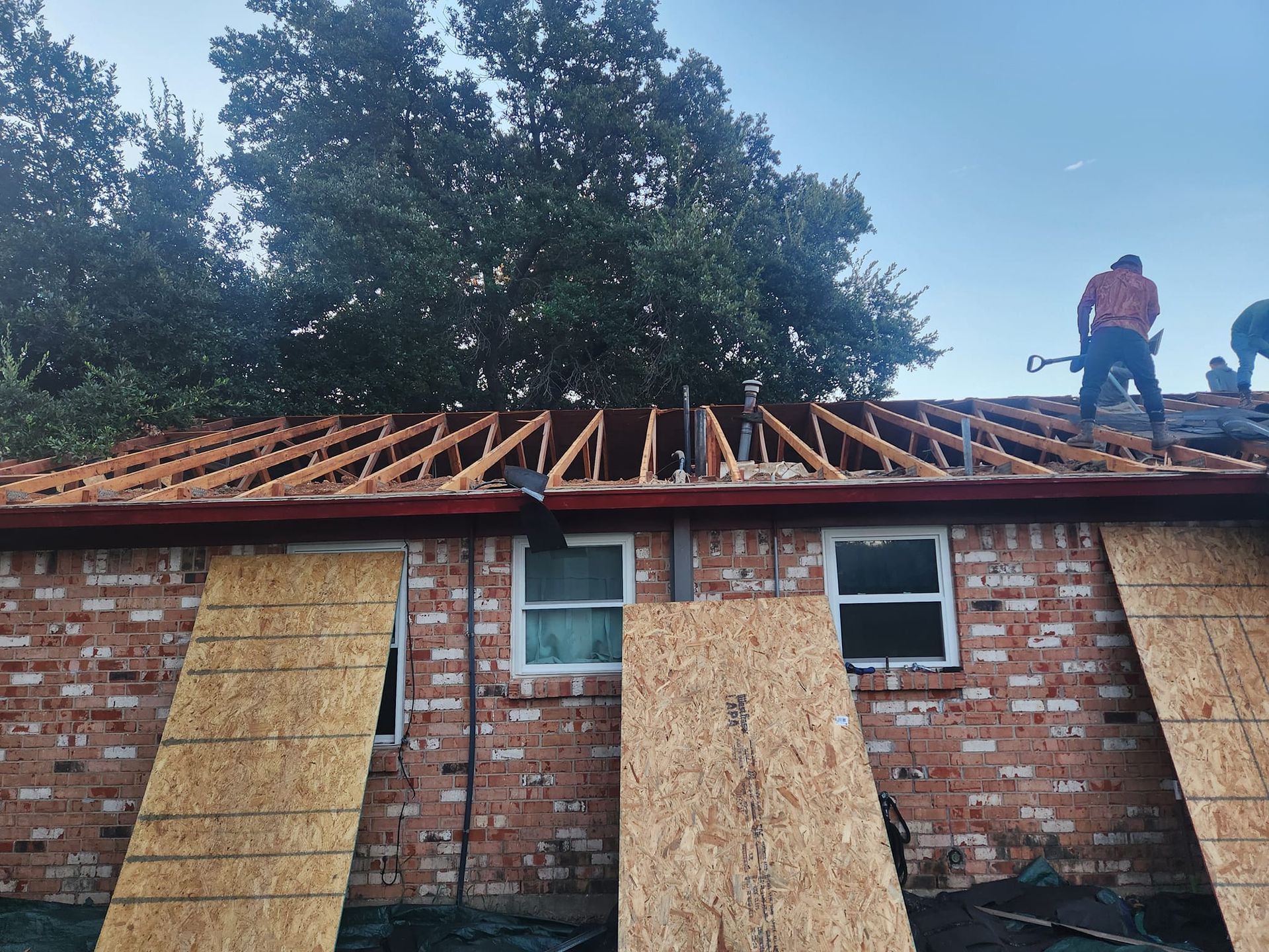 Heavy-duty recycling baler compacting cardboard waste at a construction facility for efficient site cleanup.