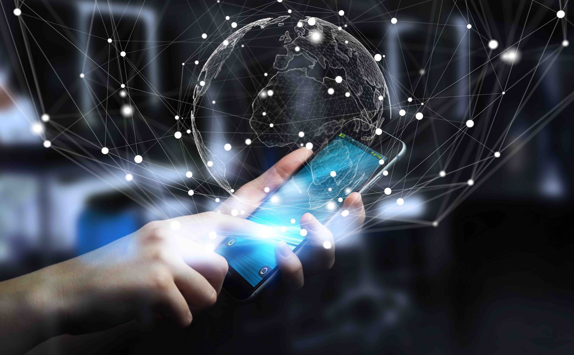 A person is holding a cell phone with a globe coming out of it.