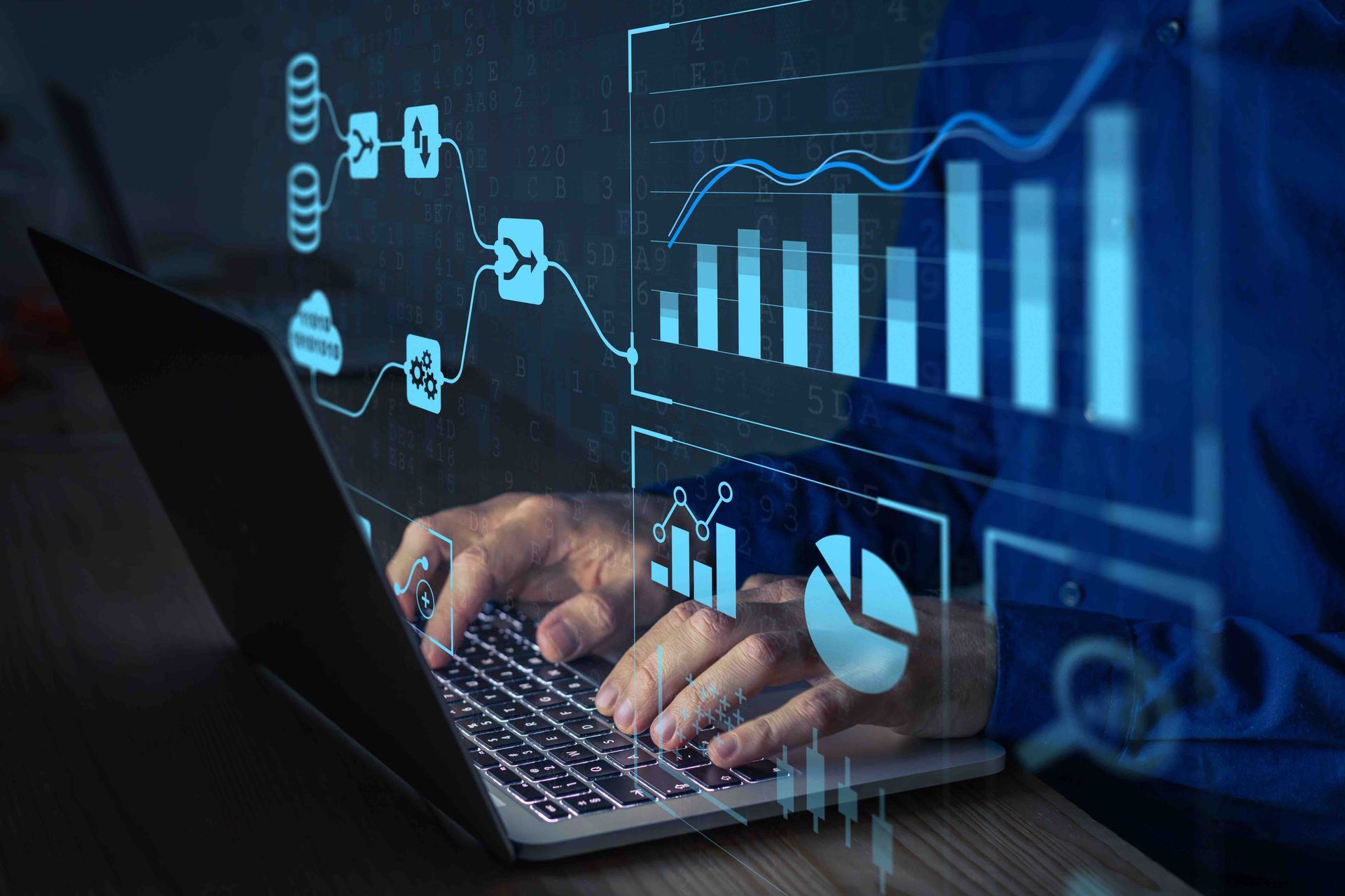 A person is typing on a laptop computer with graphs and charts coming out of it.