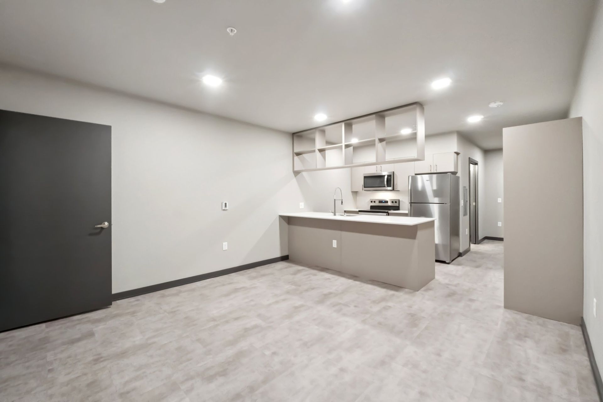 Live/work kitchen with gray cabinets