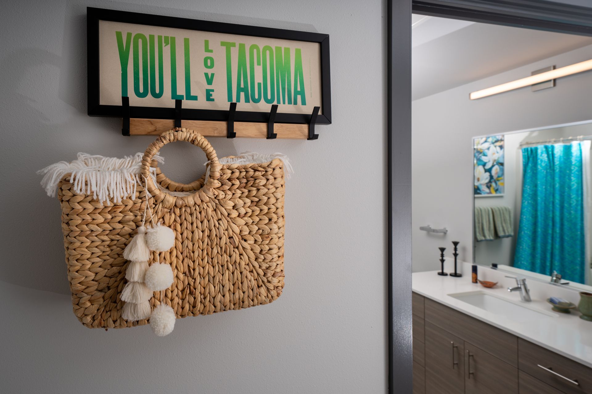 view of bathroom and sign saying you'll love Tacma