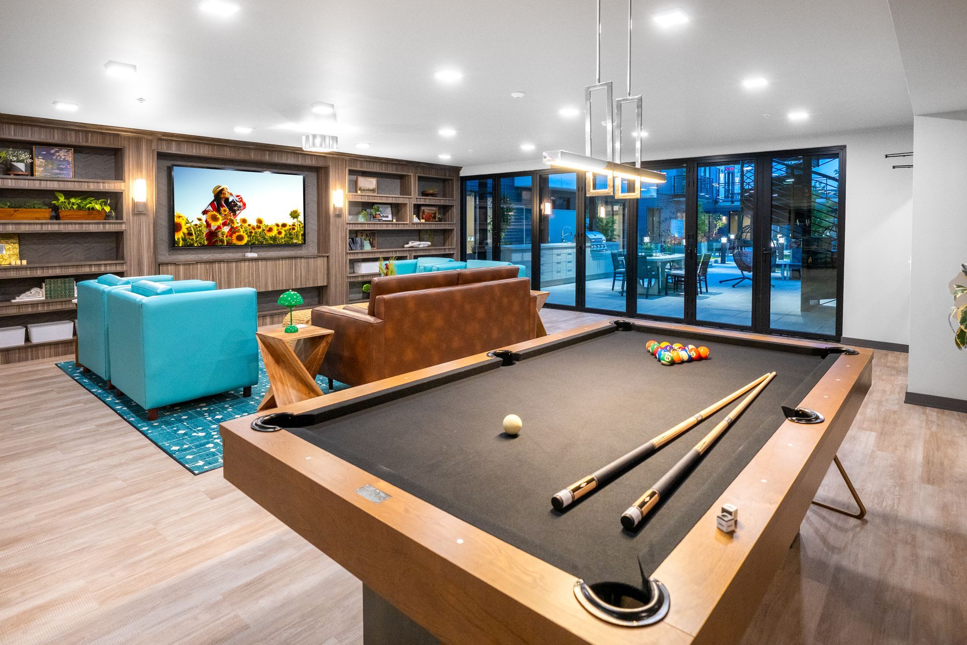 There is a pool table in the middle of the room.