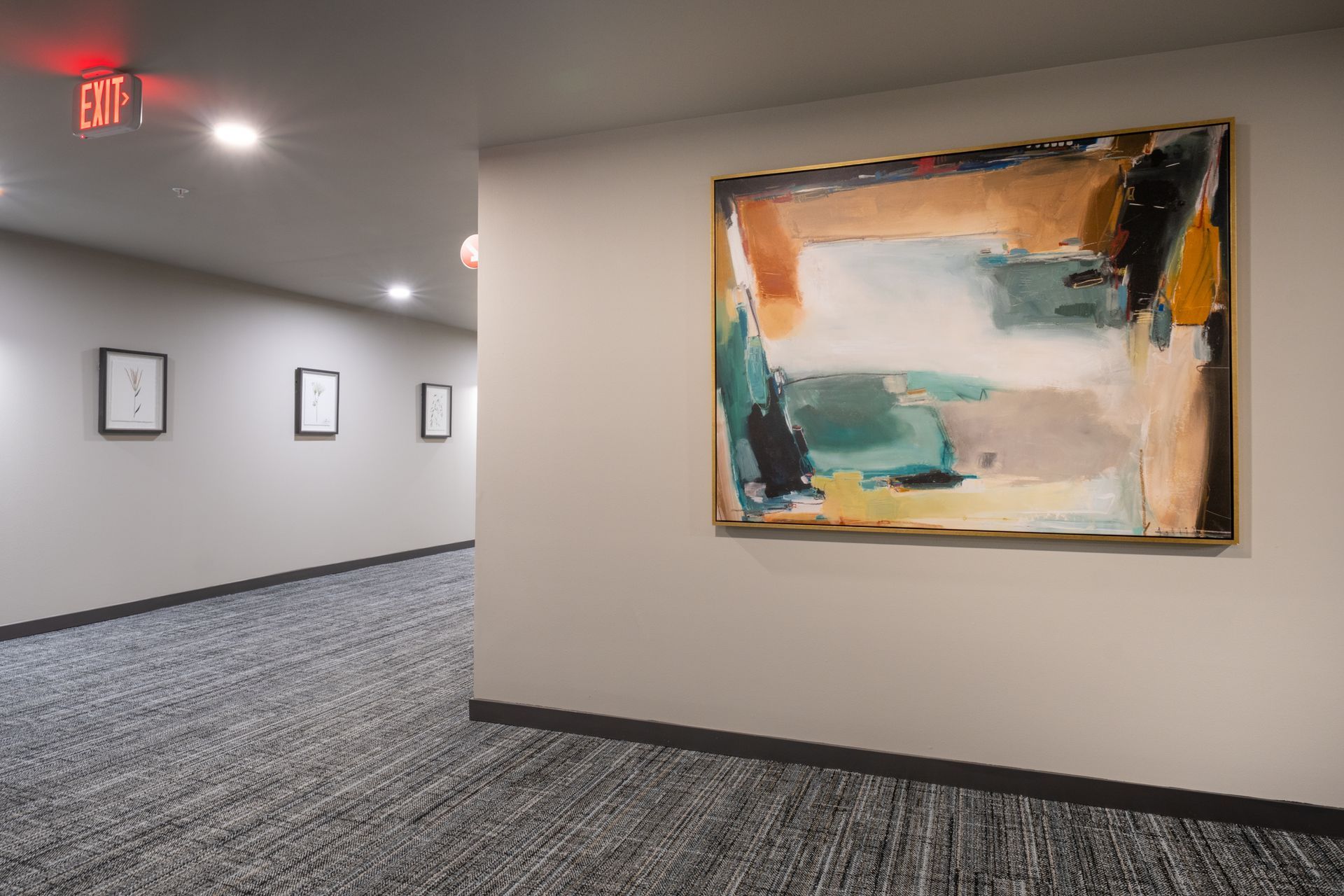 A hallway with a large painting on the wall.