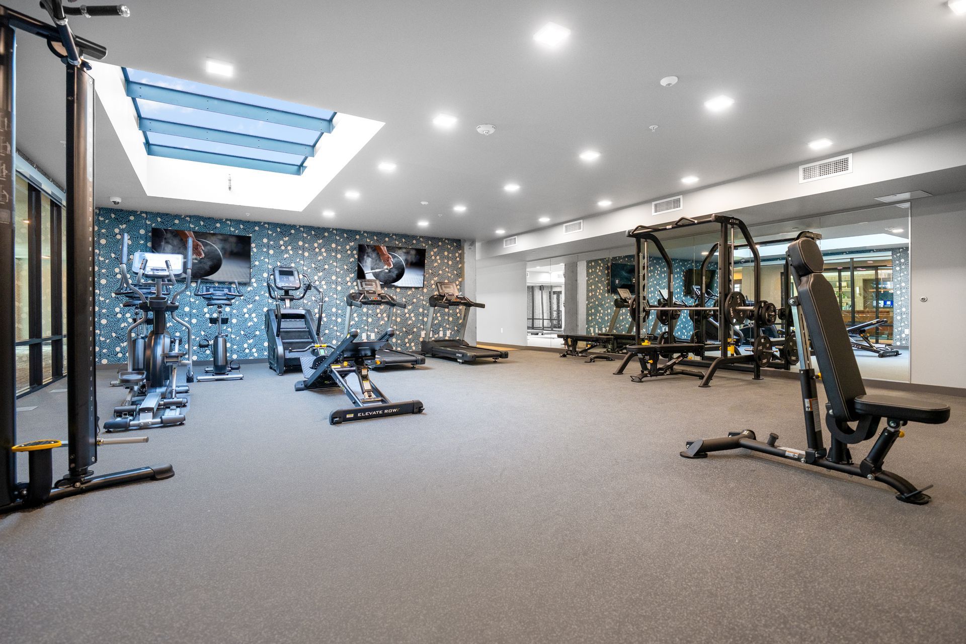 fitness area with skylight and gym equipment 