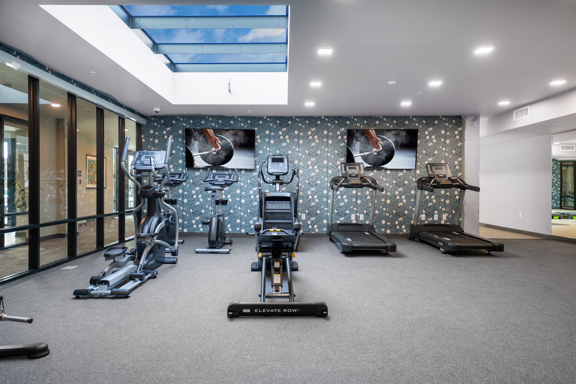 fitness room with bikes and skylight