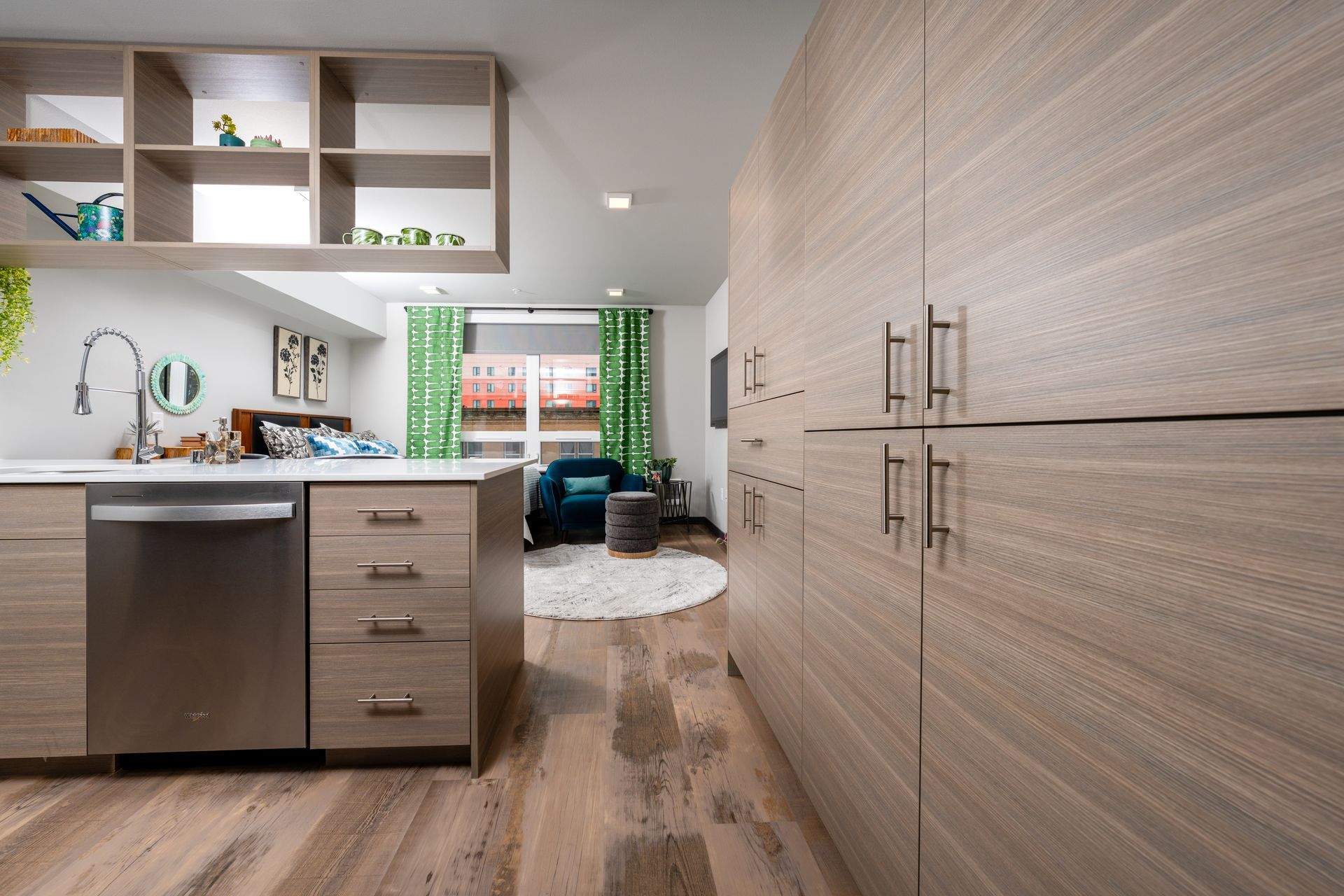 A kitchen with stainless steel appliances and wooden cabinets.
